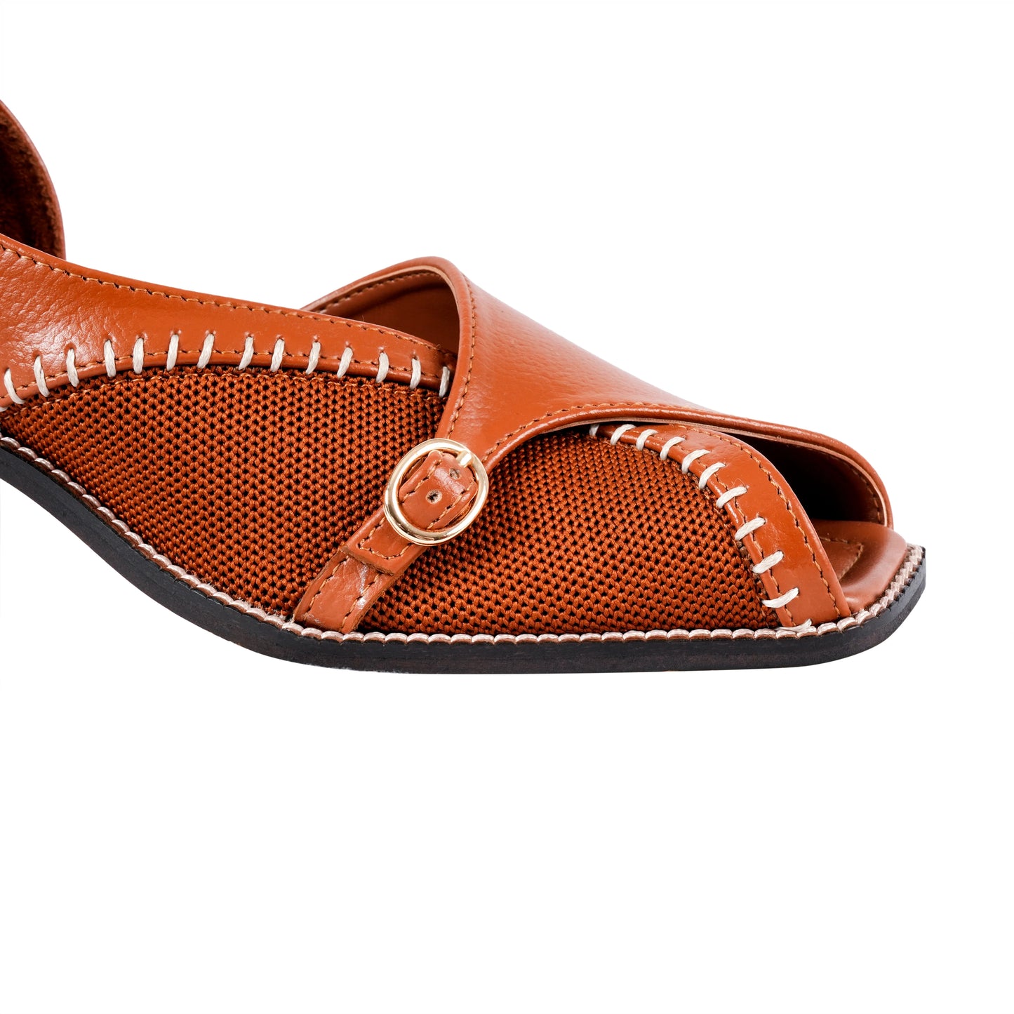 Tan sandal with a buckle on a white background
